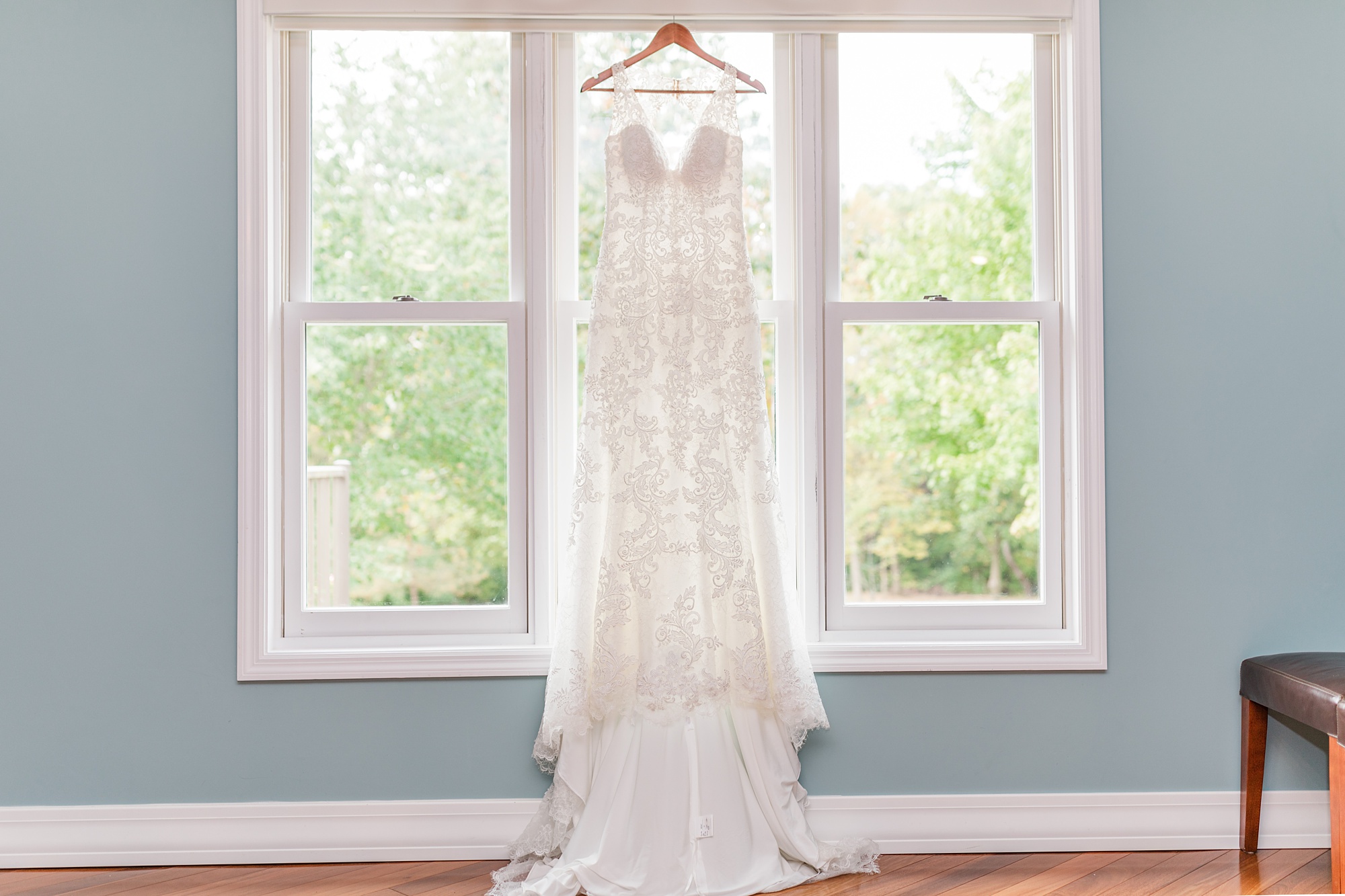 bride's dress hangs in window