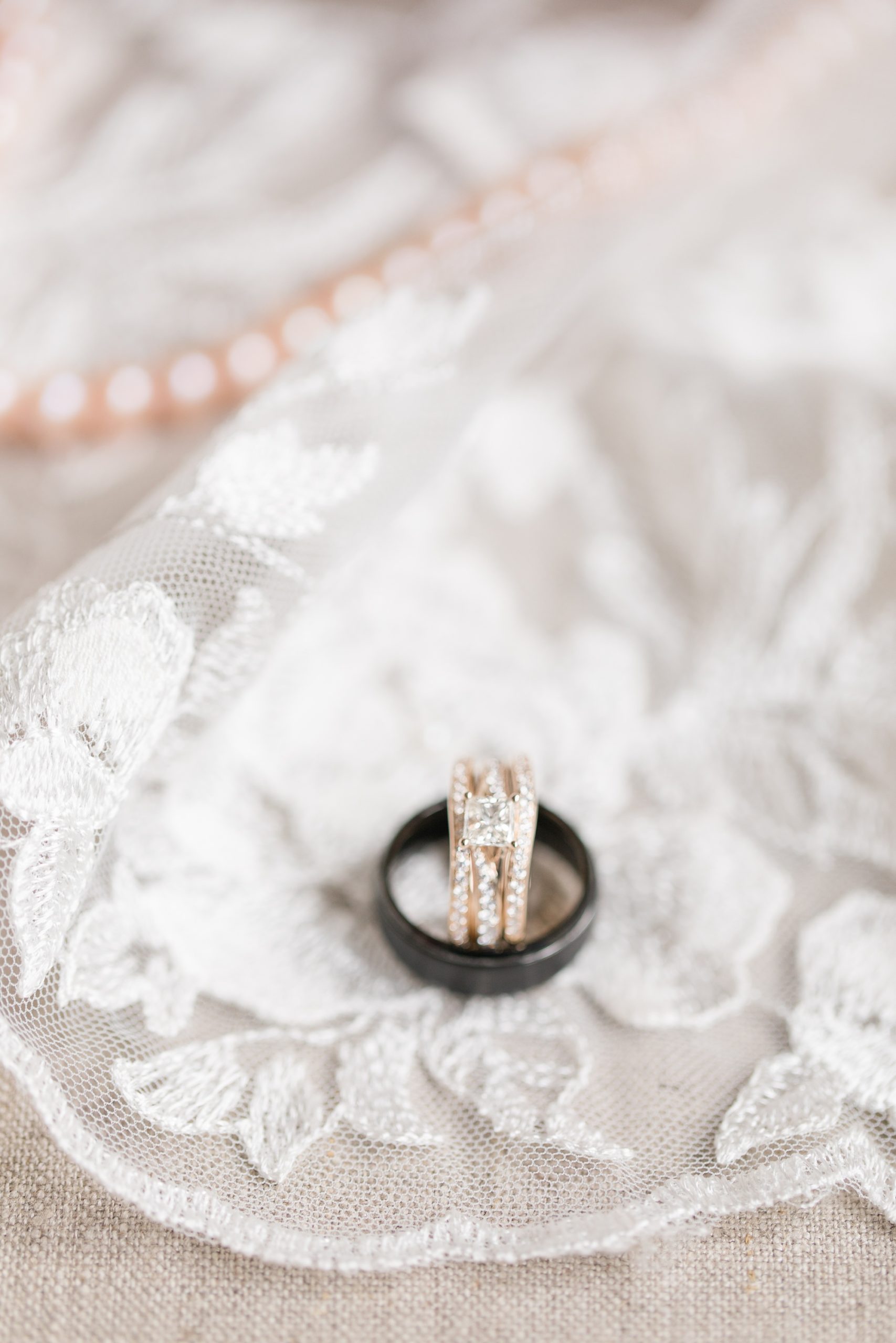 rings rest on lace veil