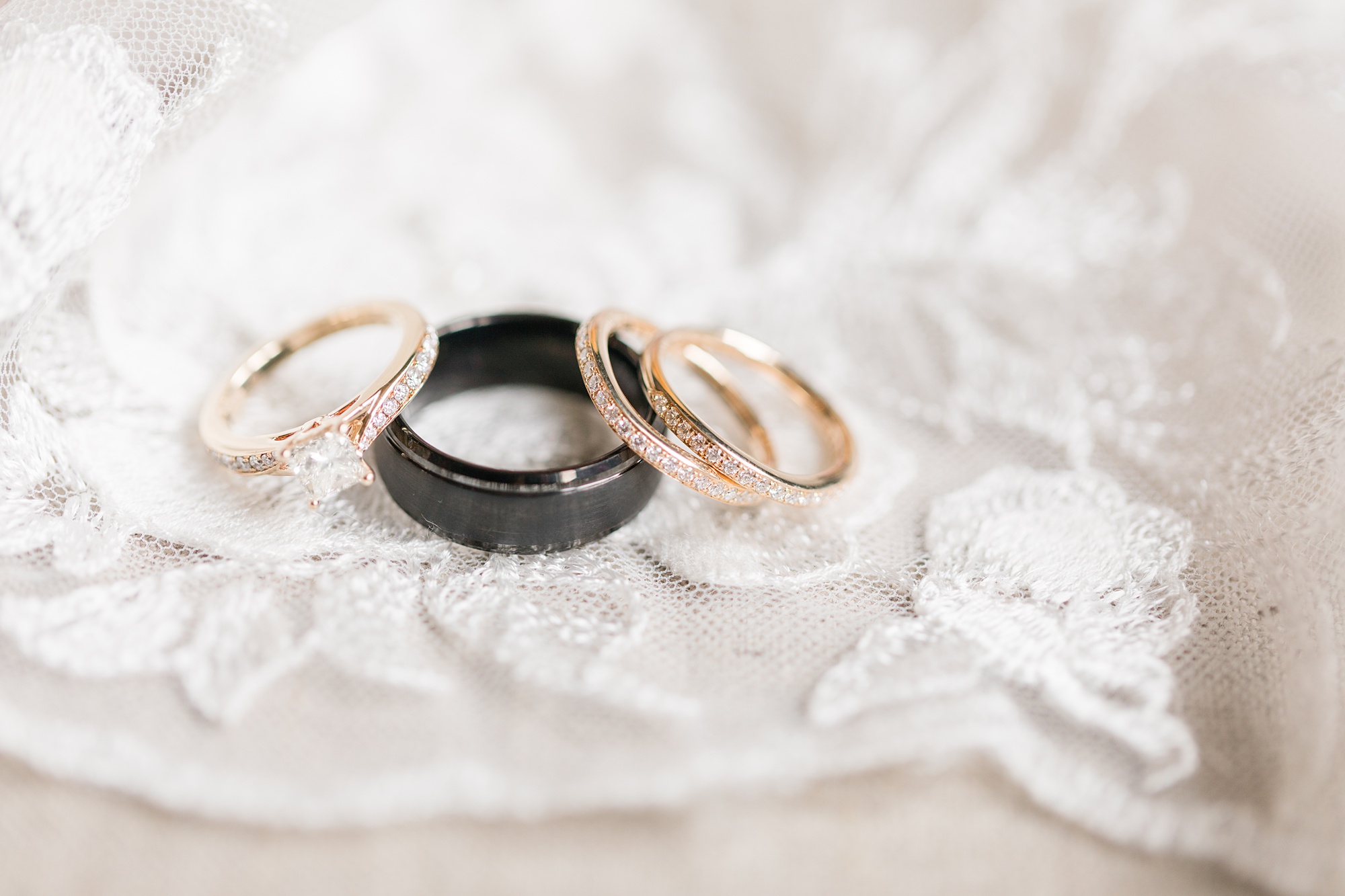 wedding rings on lace of wedding gown