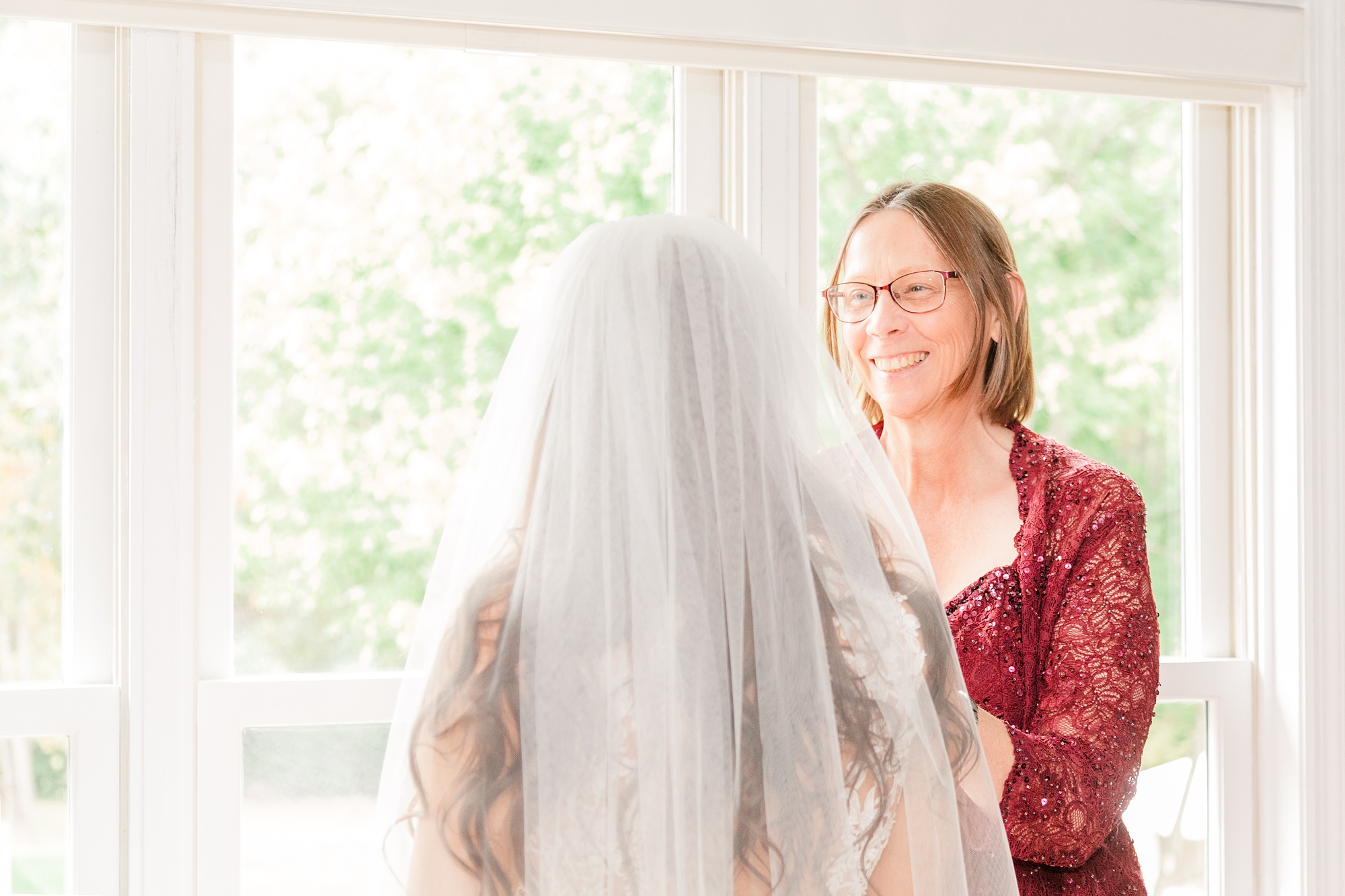 mother smiles at bride during prep for IL wedding