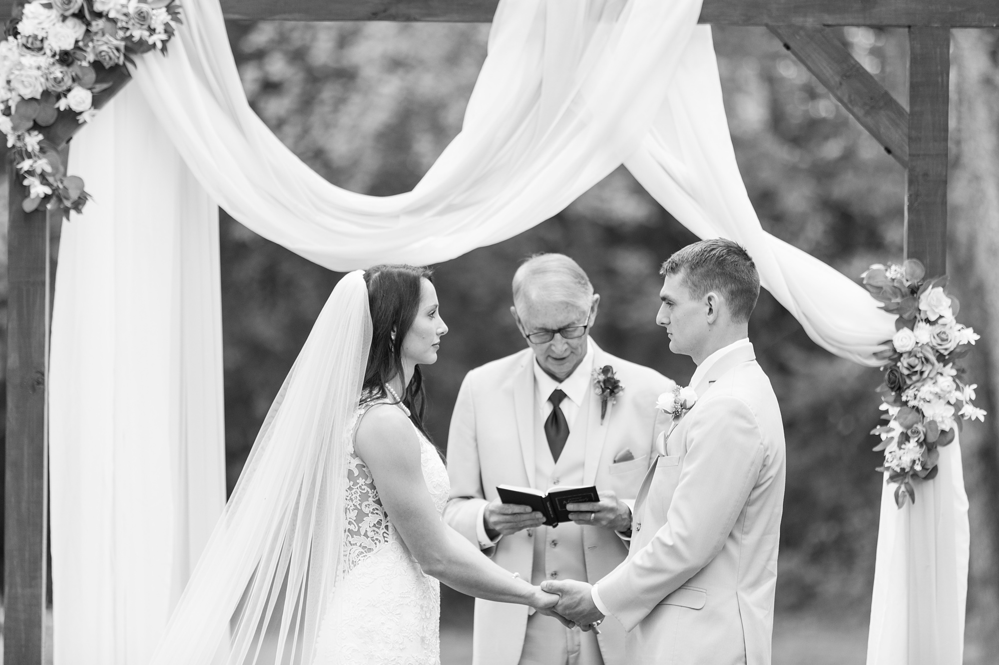 backyard wedding ceremony with father officiating