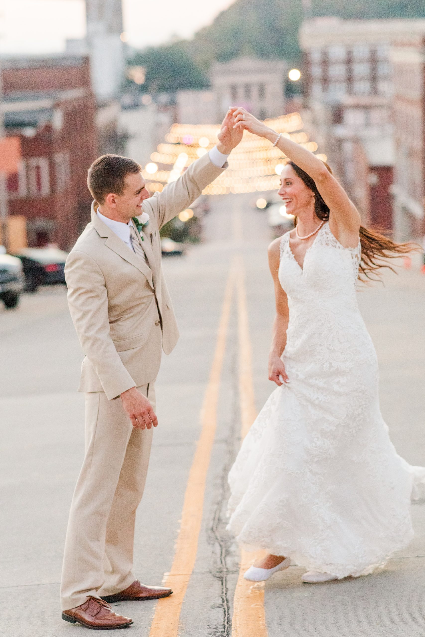 groom twirls bride during backyard wedding