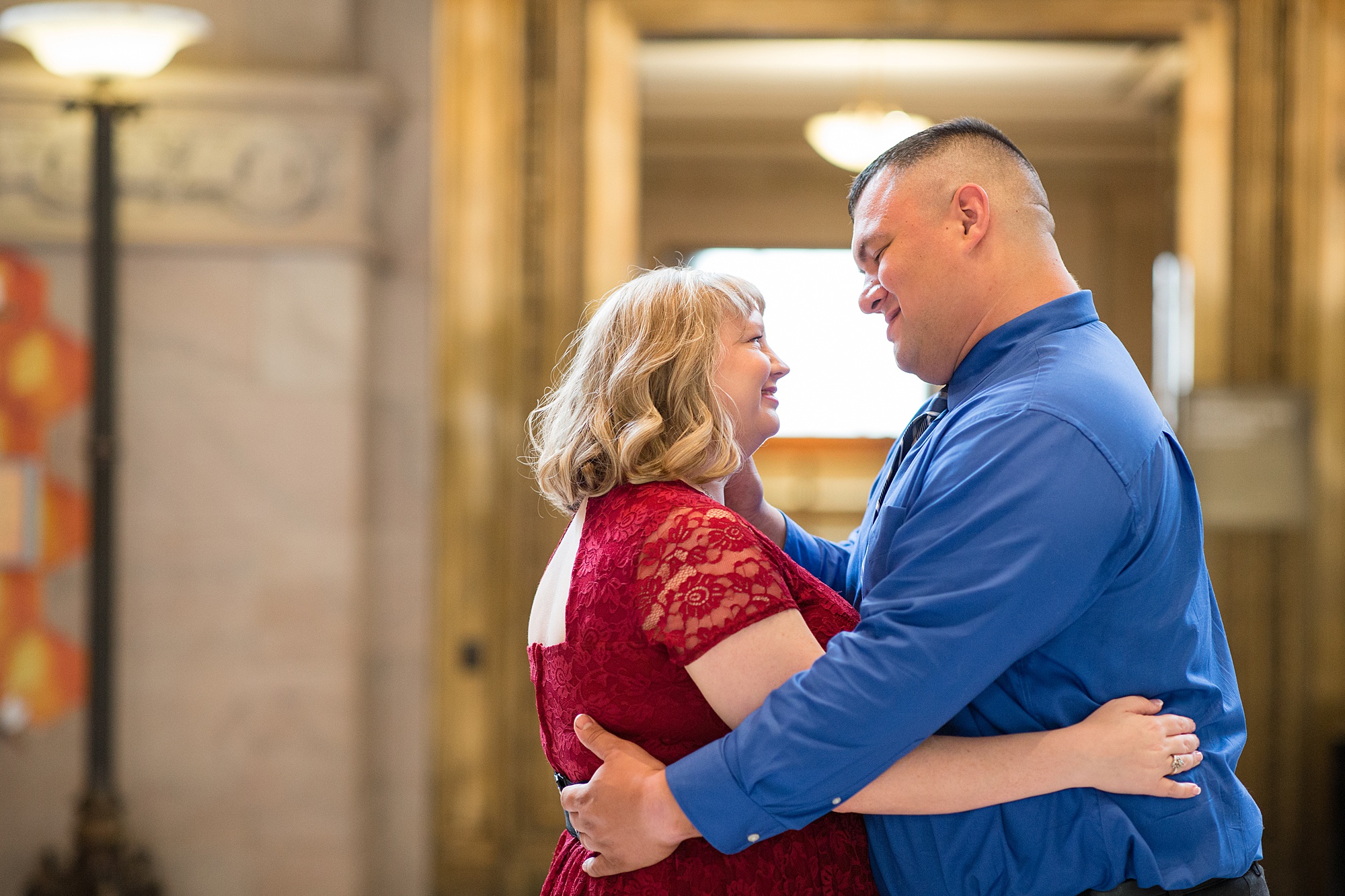 couple hugs each other in lobby of Central Library