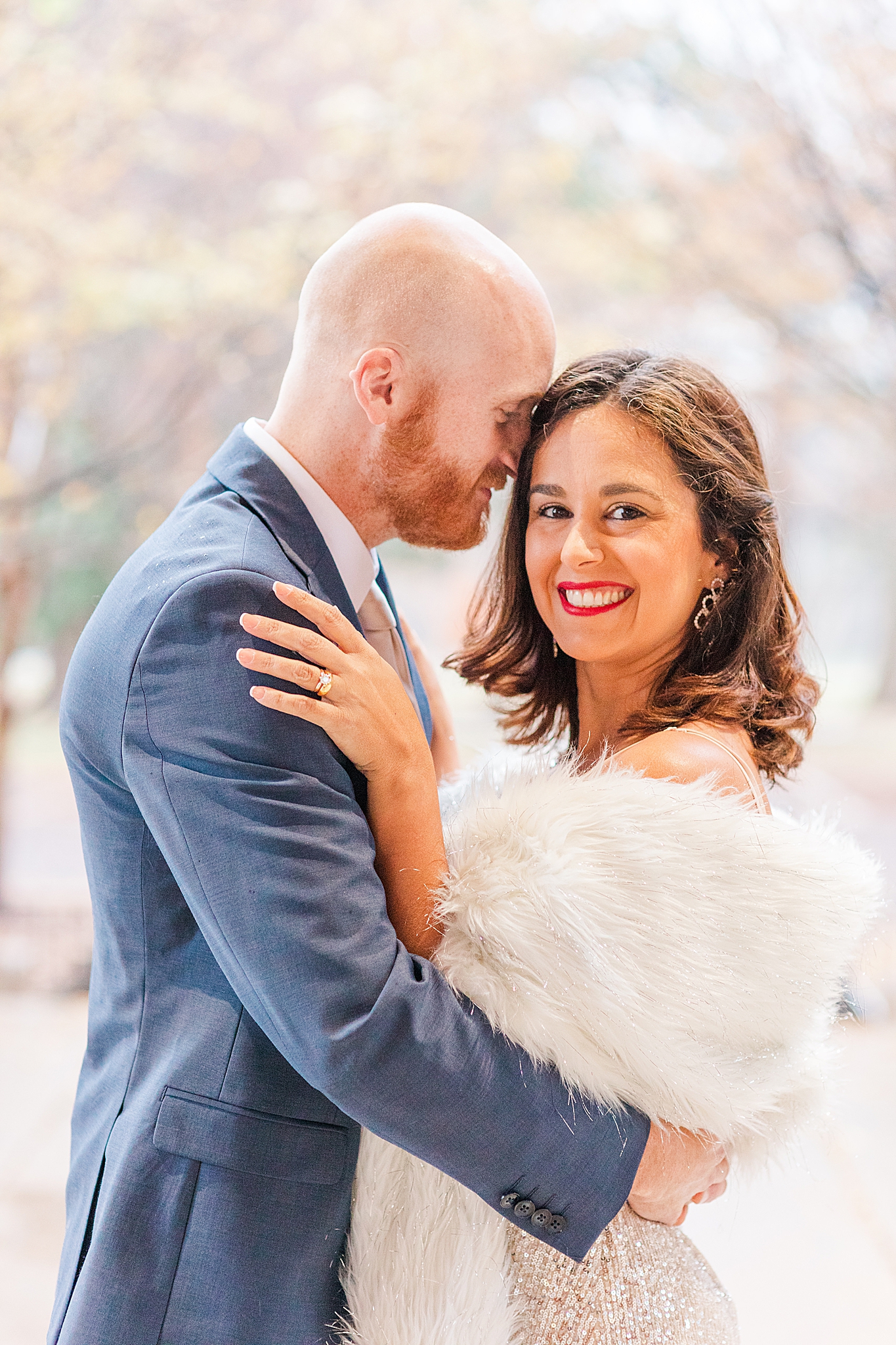 groom nuzzles bride's forehead during winter engagement photos at Forest Park
