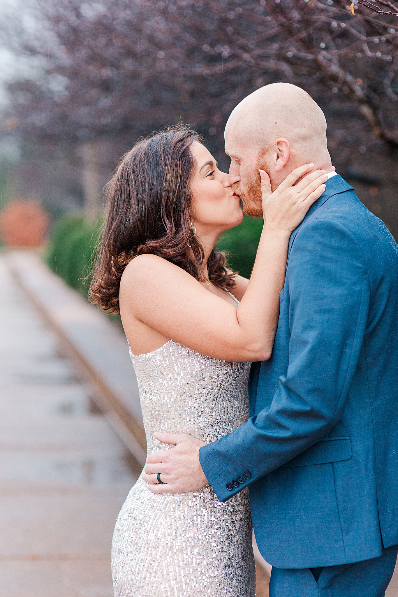 newlyweds kiss during winter engagement session at Forest Park