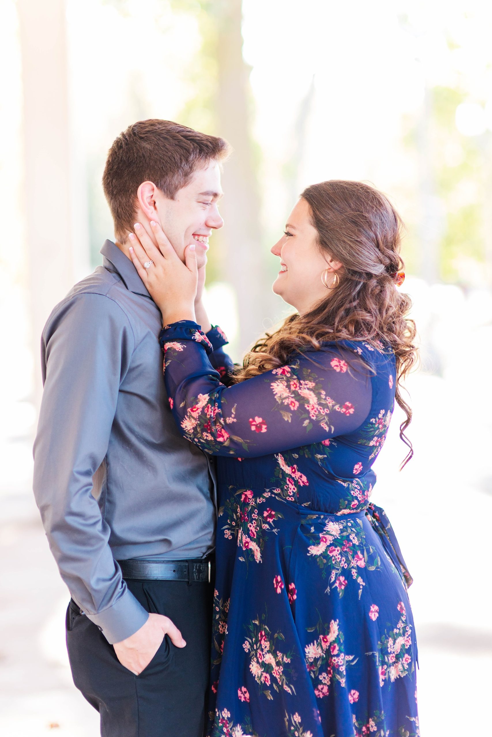 bride and groom laugh together during fall Forest Park engagement session