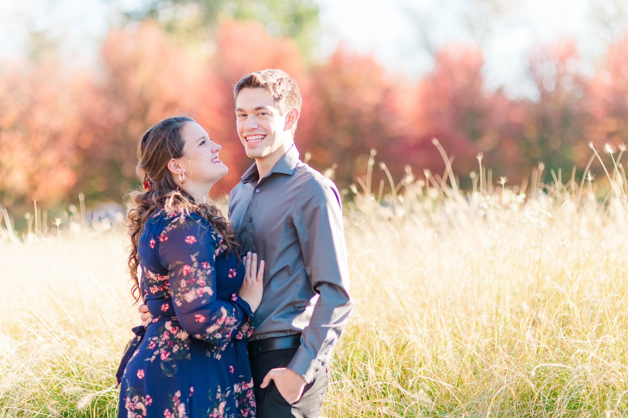bride and groom stand by tall grass during Forest Park engagement session