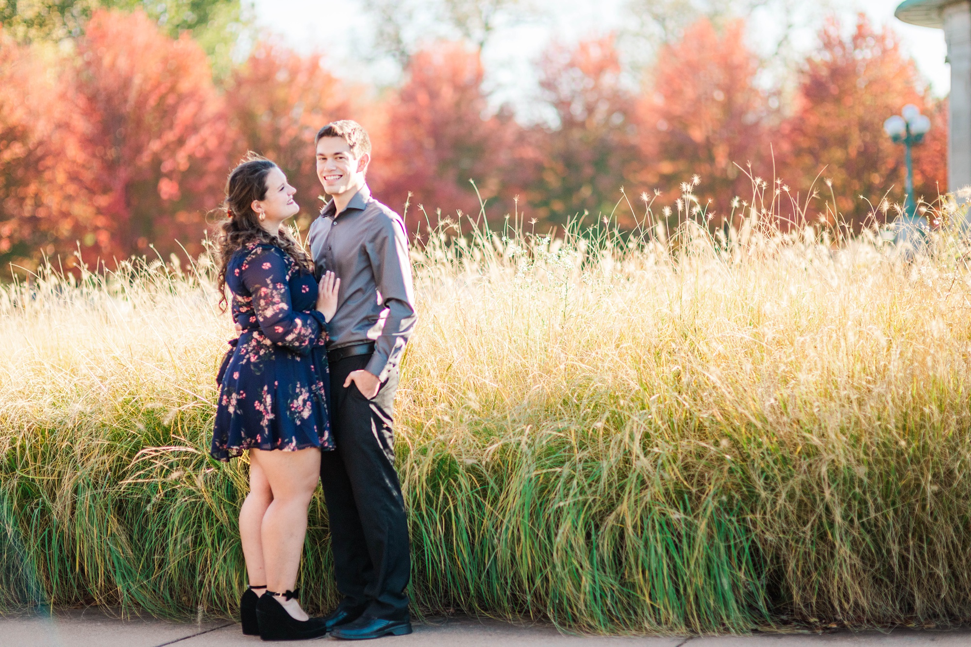 bride and groom pose by tall grass in St. Louis