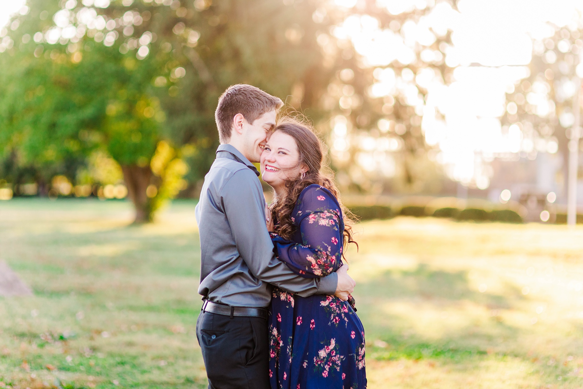 bride laughs leaning into groom during Forest Park engagement session