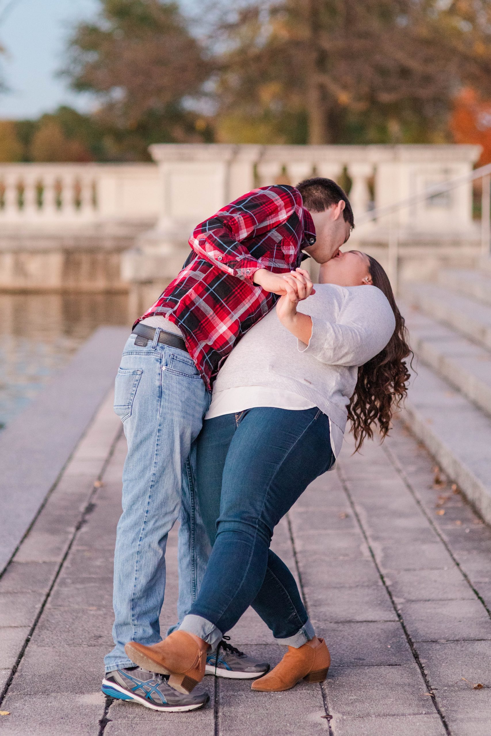 groom dips fiancee during engagement photos