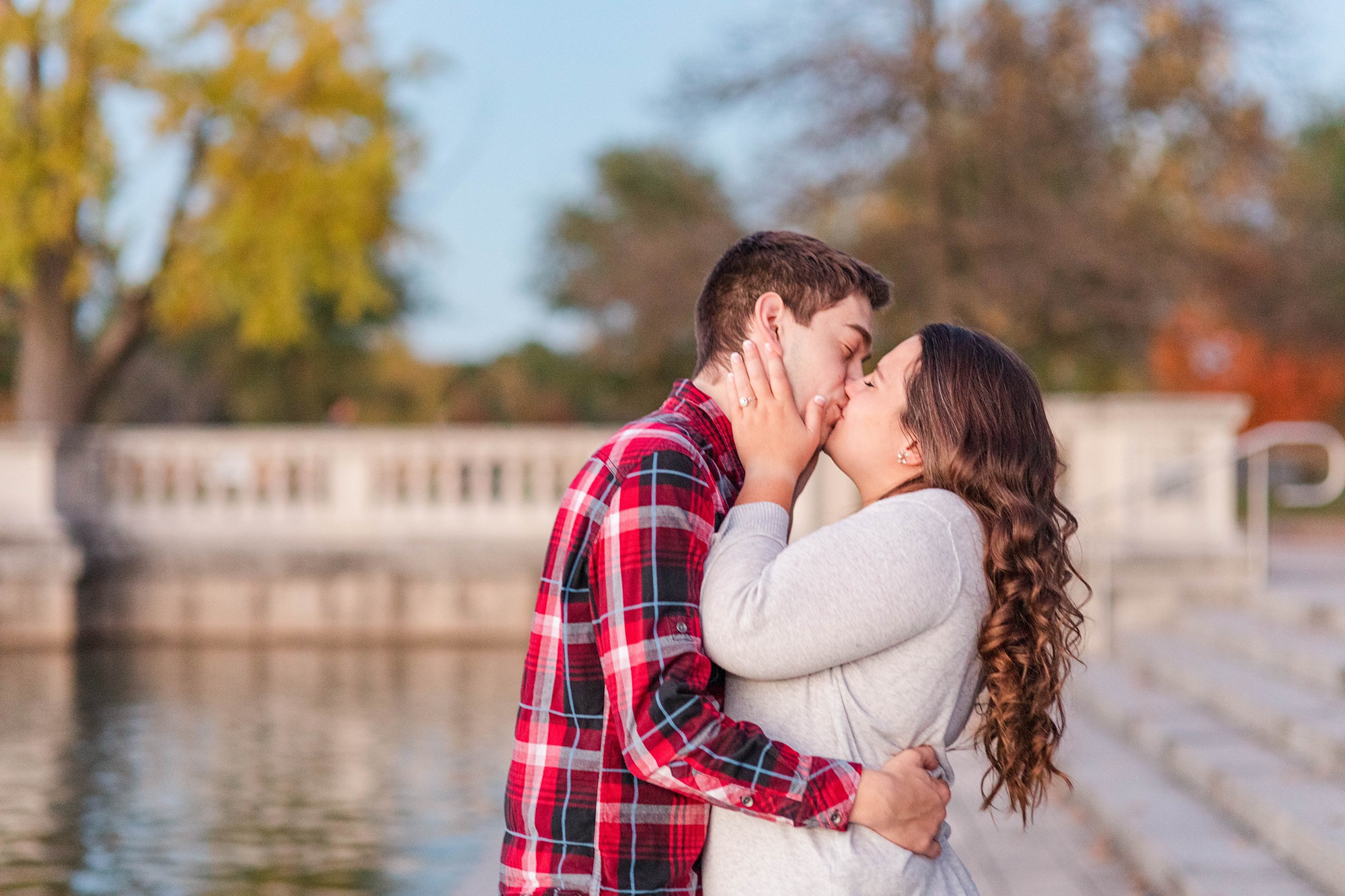 engaged couple kisses during Forest Park engagement session