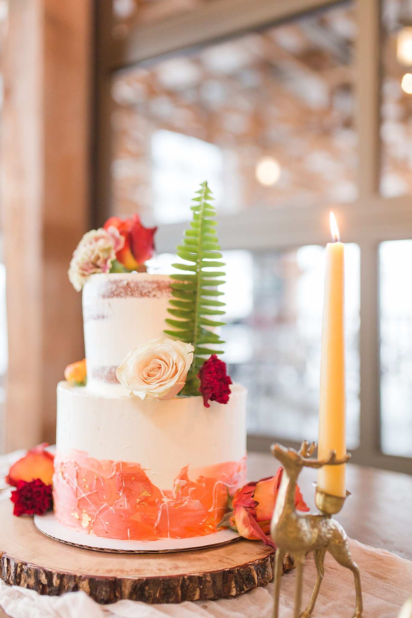 tiered wedding cake with coral accents