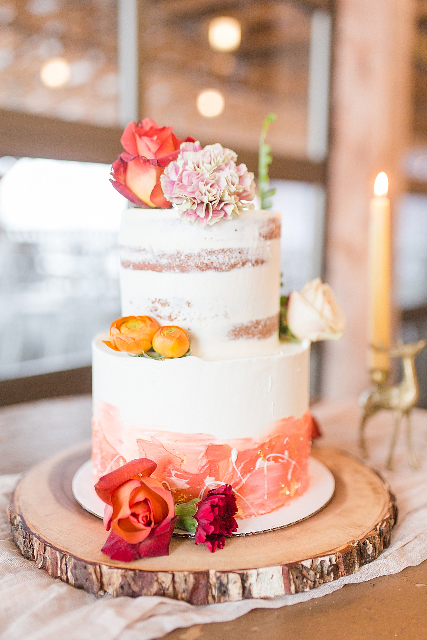 naked wedding cake with floral topper