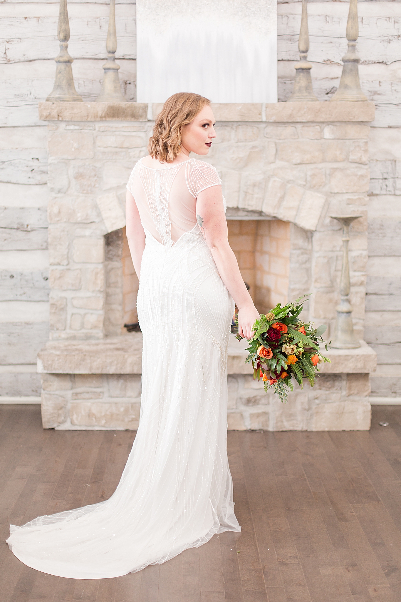 bride stands in front of stone fireplace at Haue Valley