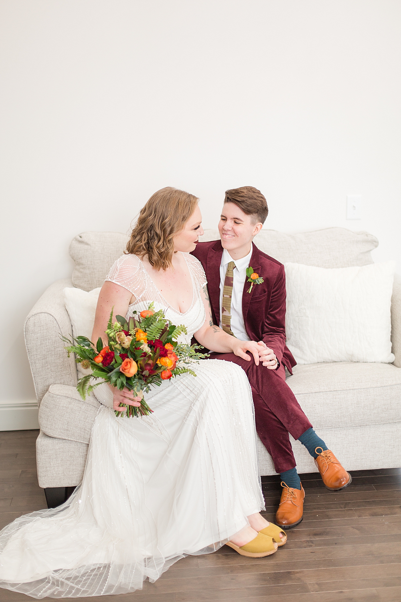 couple sits on couch at Haue Valley wedding