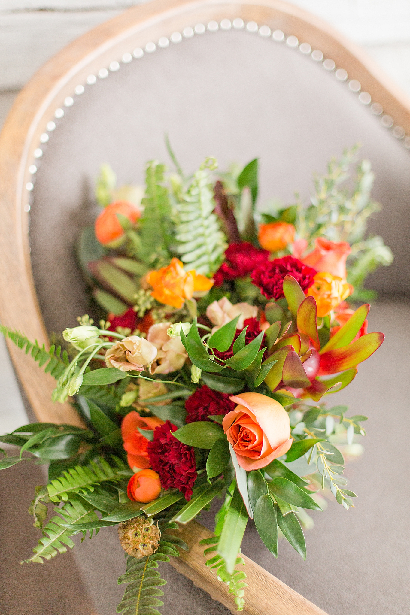 bright bouquet of orange and red flowers for bride