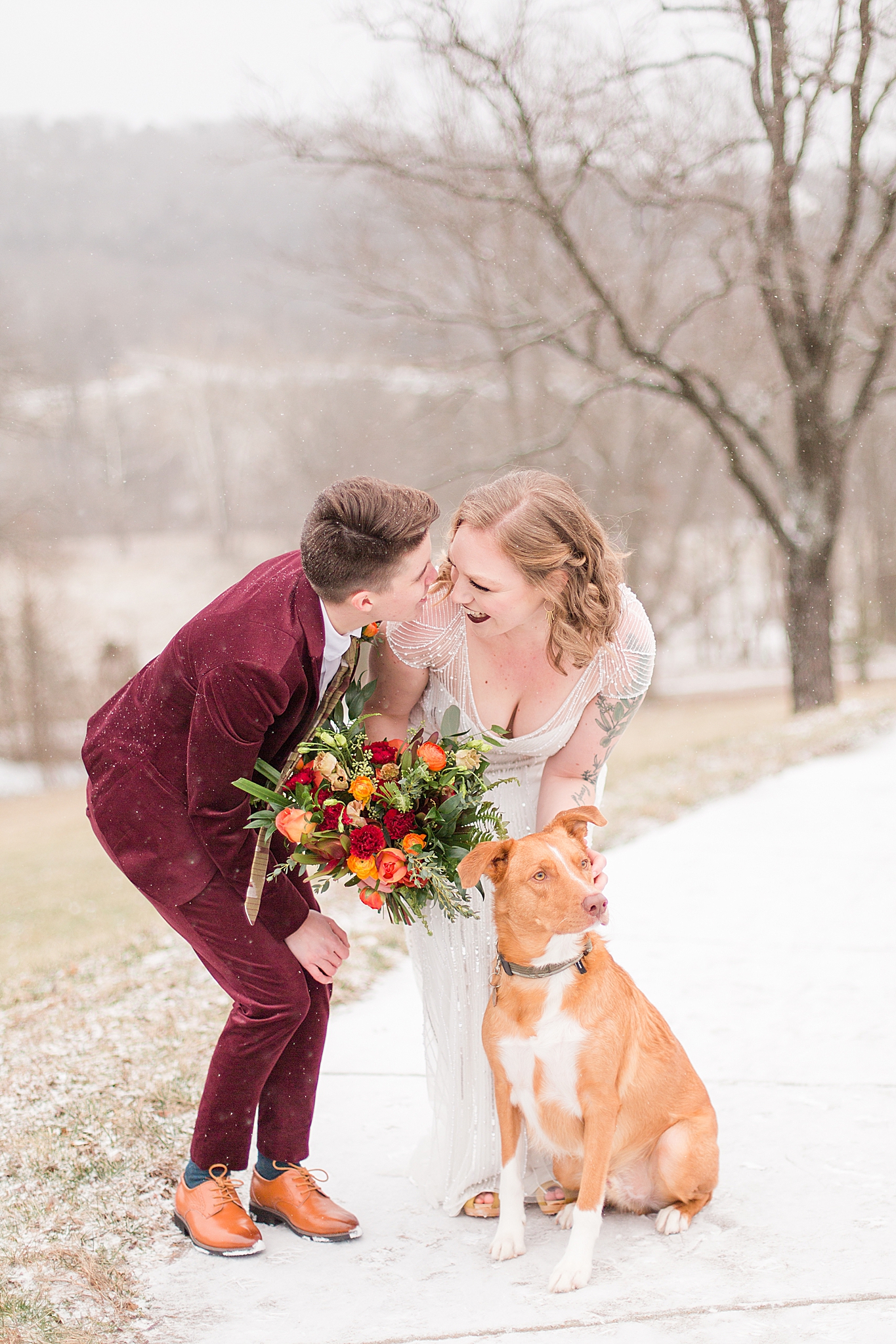 brides pose with dog in the snow during Haue Valley wedding