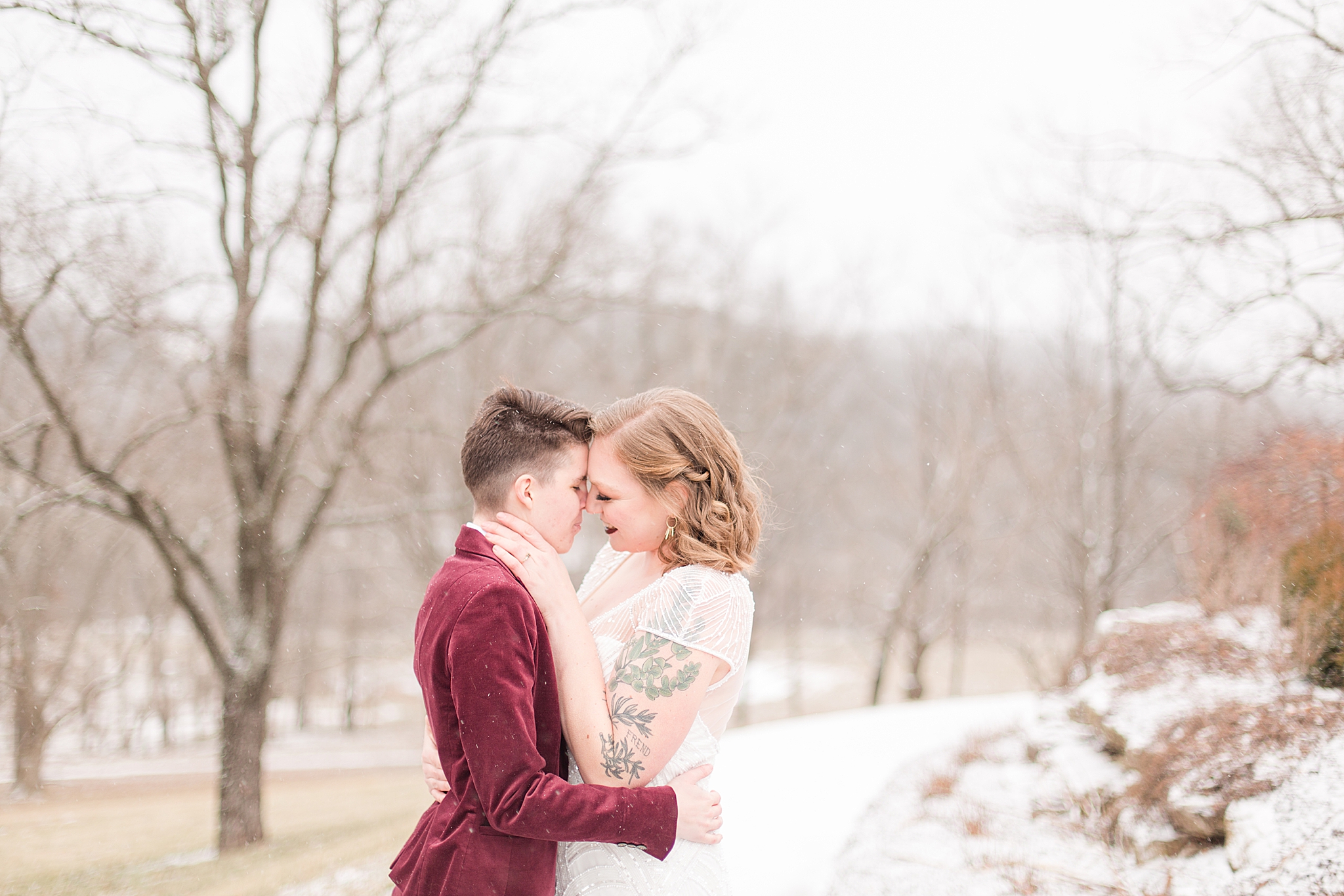 couple poses in snow during winter styled shoot at Haue Valley