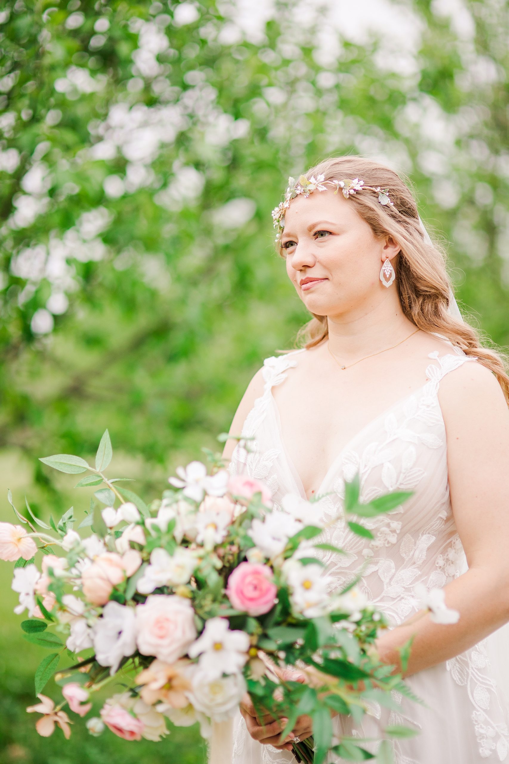 bride in floral crown holds bouquet of flowers