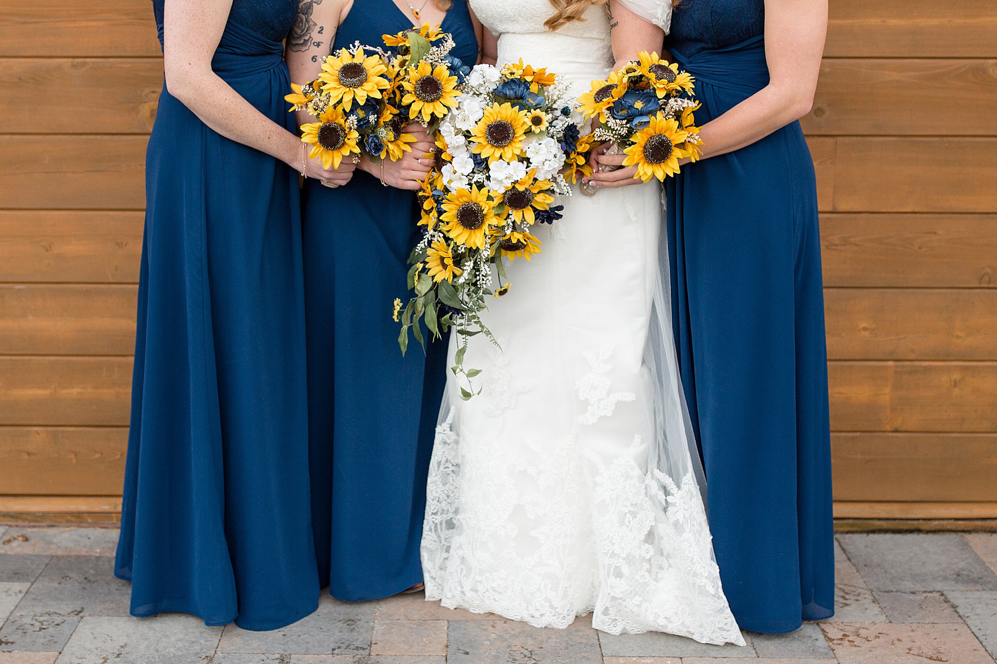 bridesmaids hold bouquet of sunflowers for Quail Ridge Lodge wedding