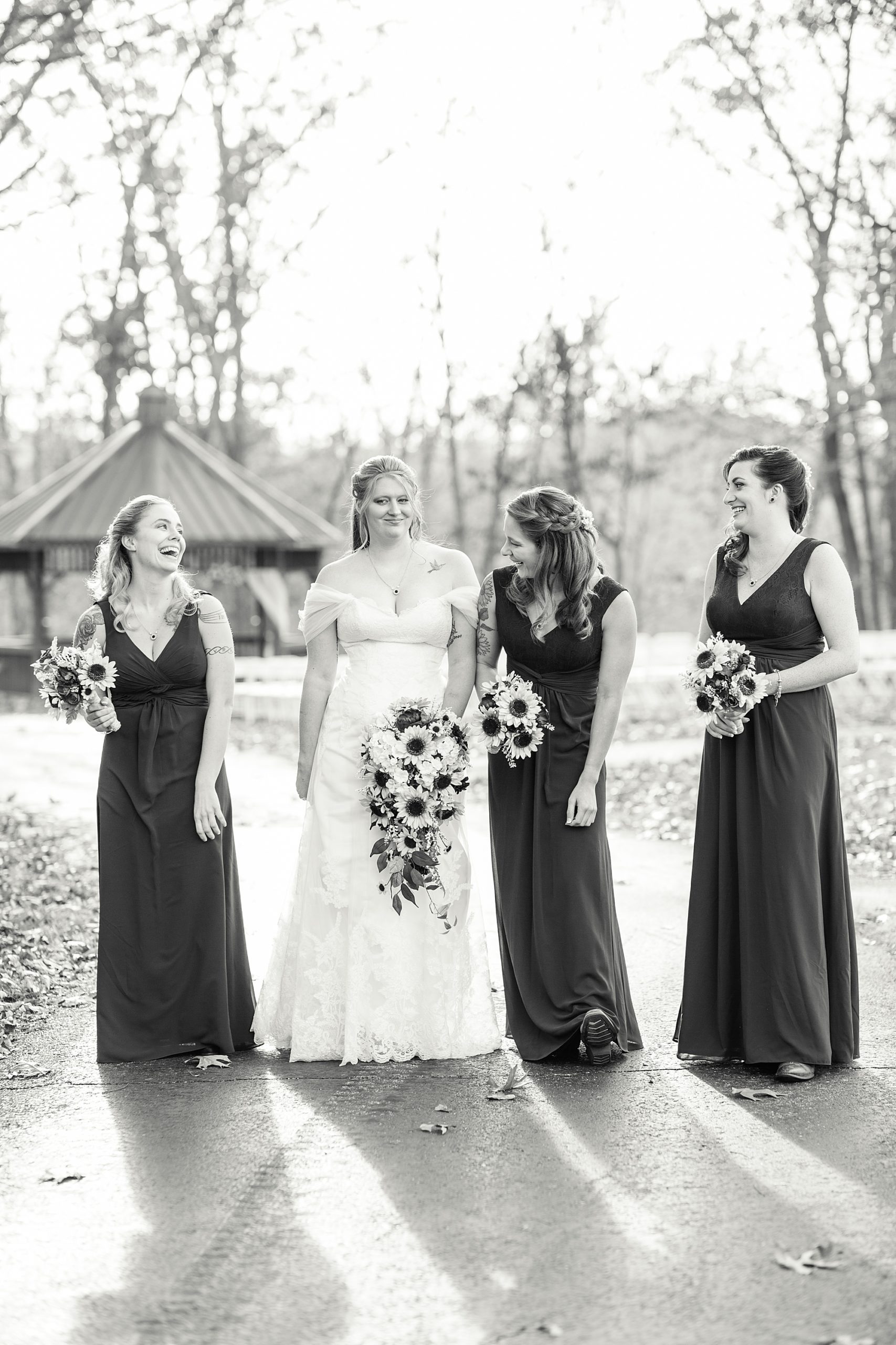 bride walks with bridesmaids holding sunfowers