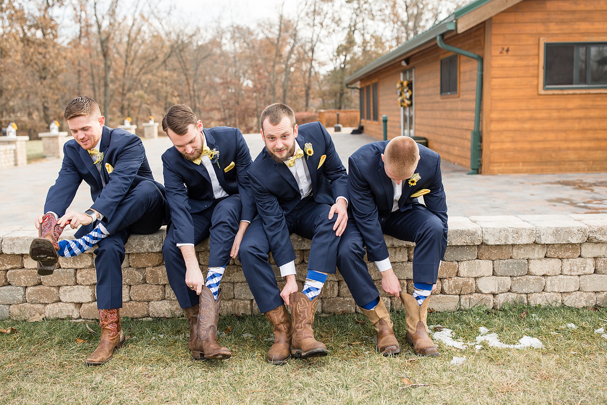 groom and groomsmen show off boots at Quail Ridge Lodge