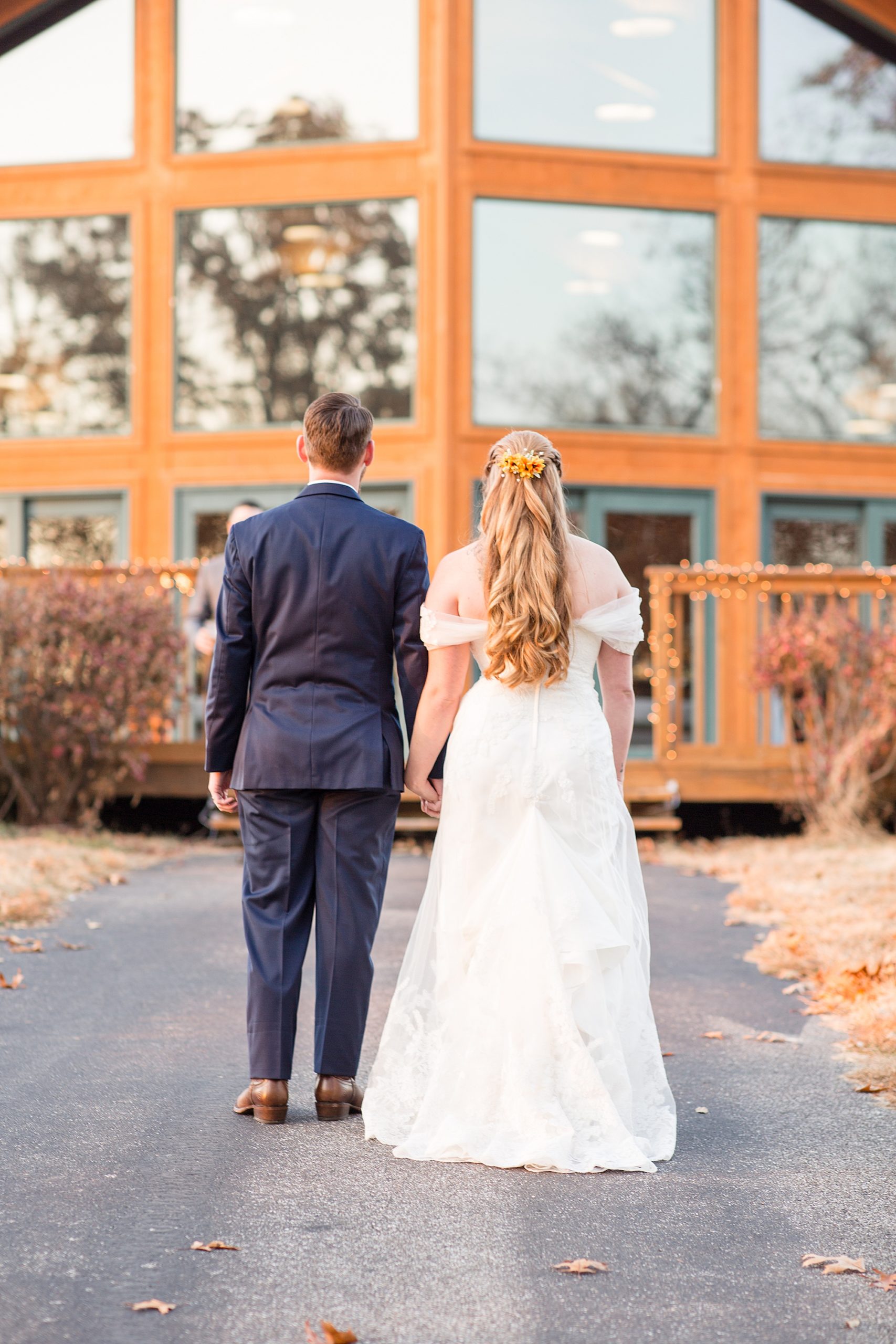 bride and groom walk to Quail Ridge Lodge