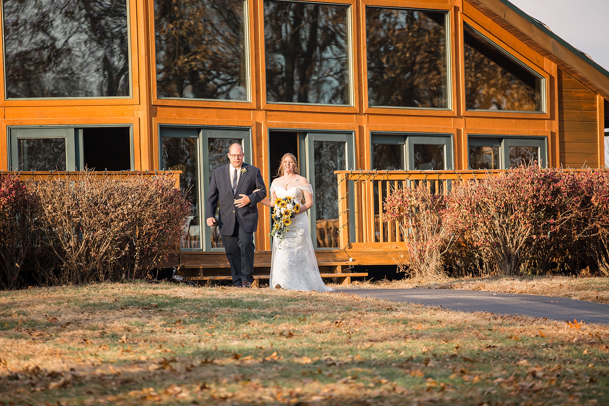 bride walks down aisle for outdoor wedding ceremony in Wentzville MO