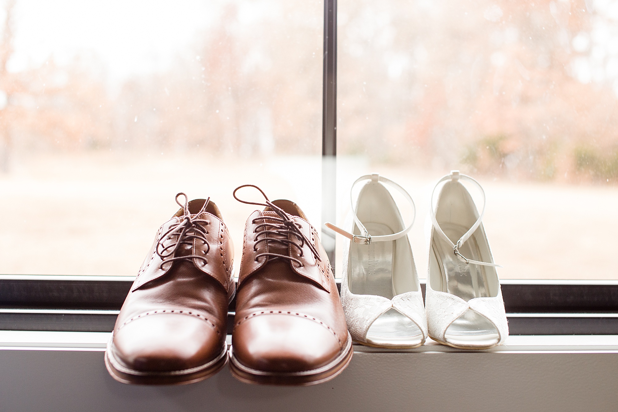 bride and groom shoes sit on window sill