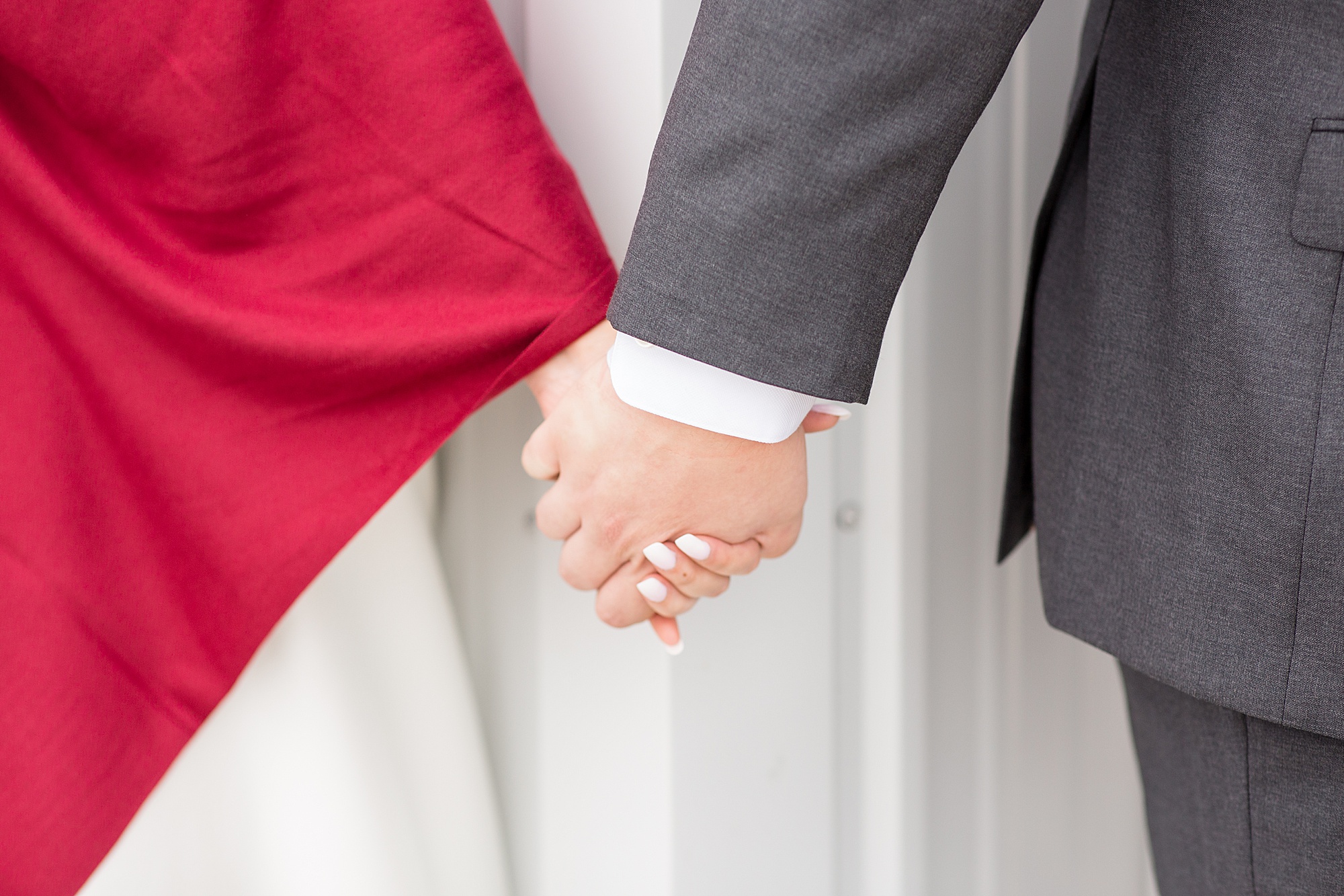 bride and groom hold hands during first touch