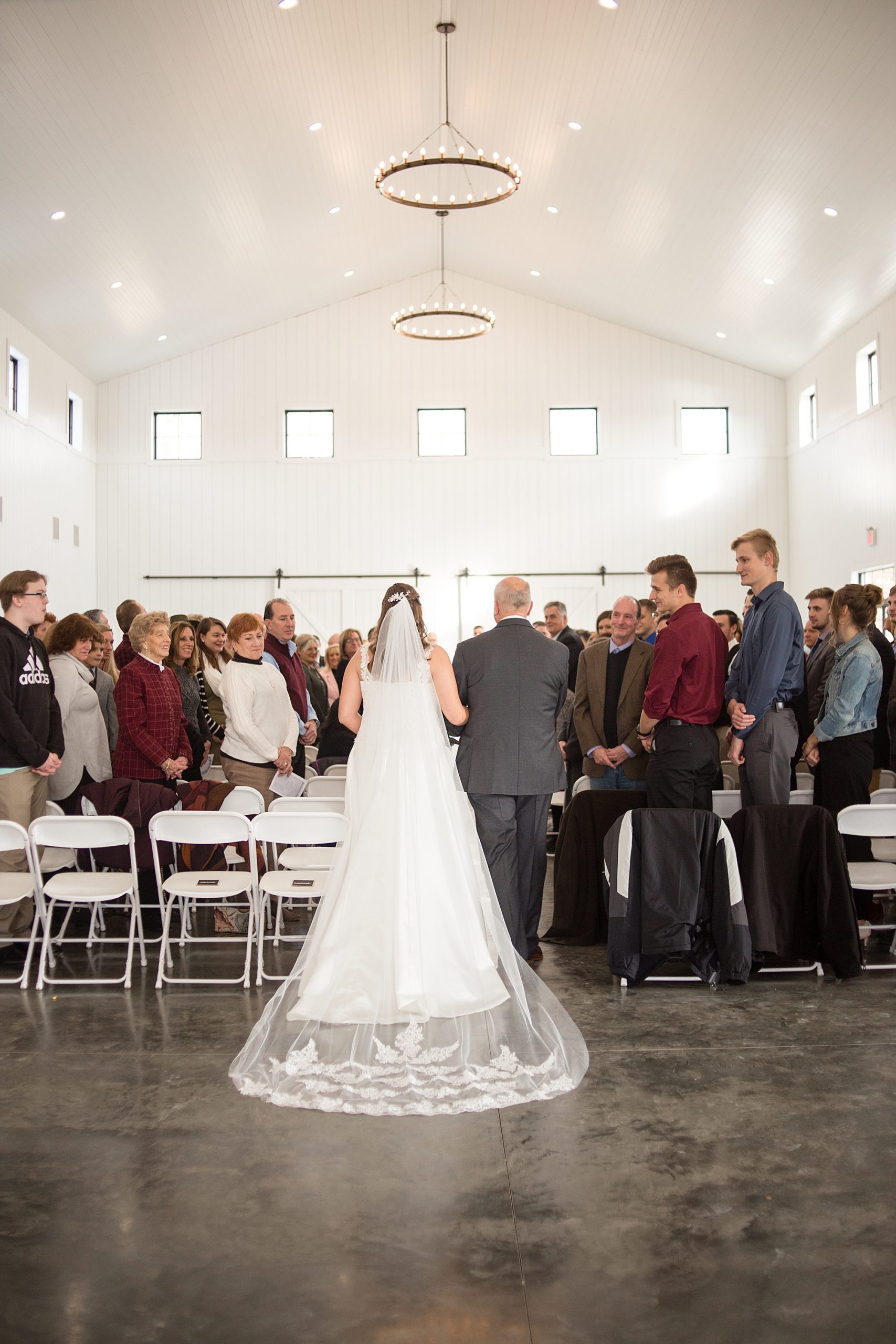 bride walks down aisle at Redemption Ranch