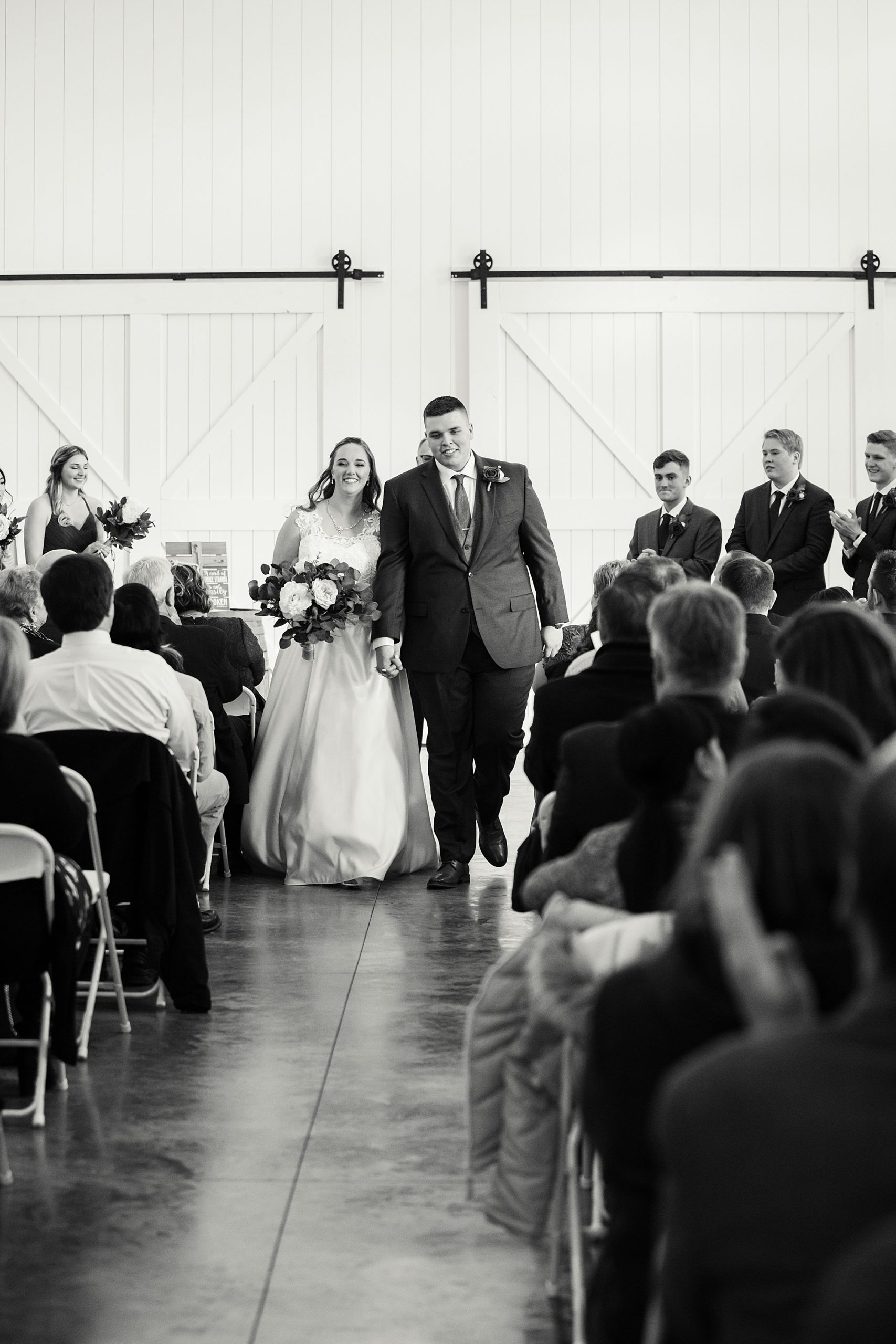 newlyweds walk up aisle at Redemption Ranch
