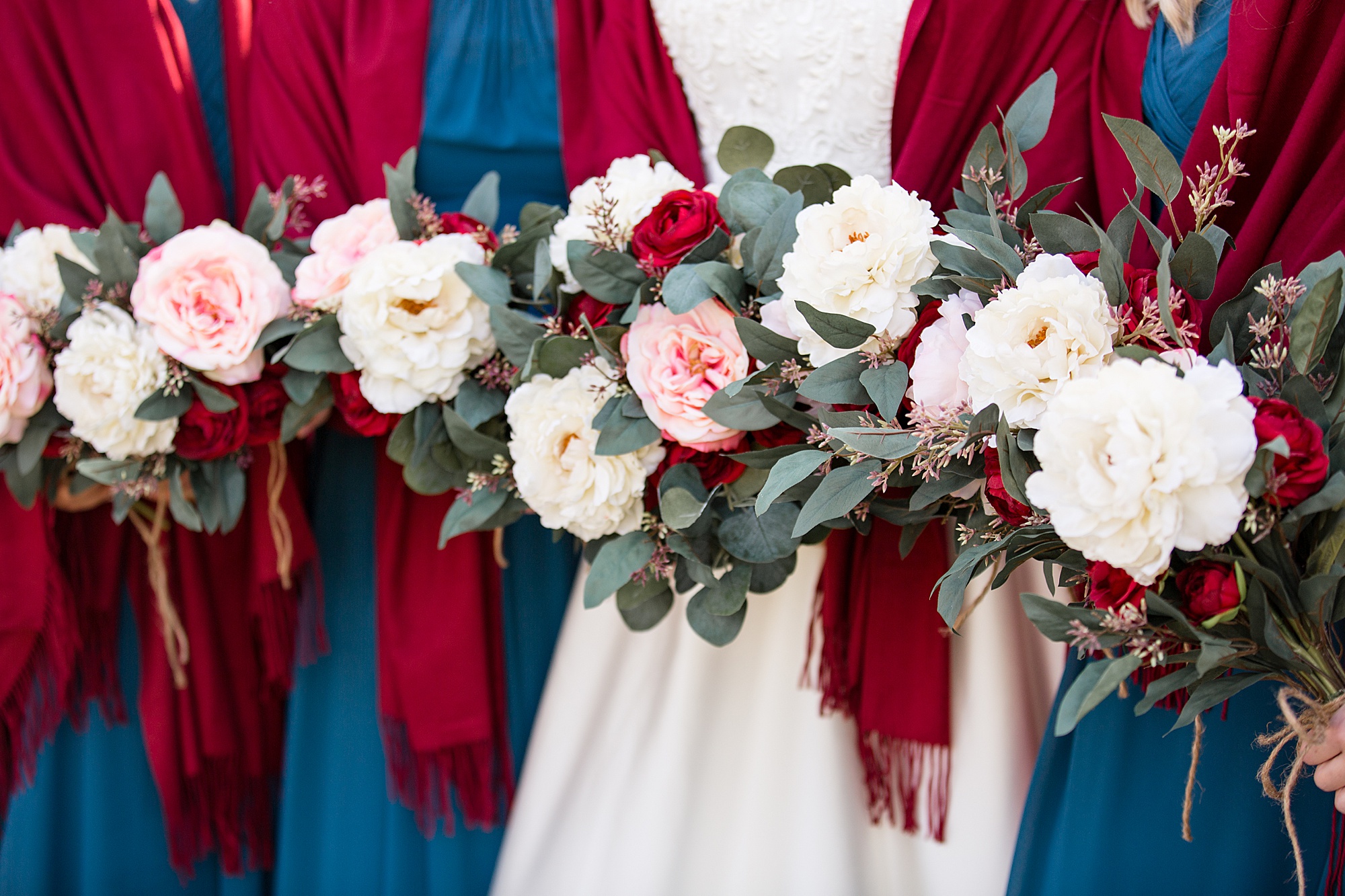 bridesmaids hold bouquets of pink and white flowers