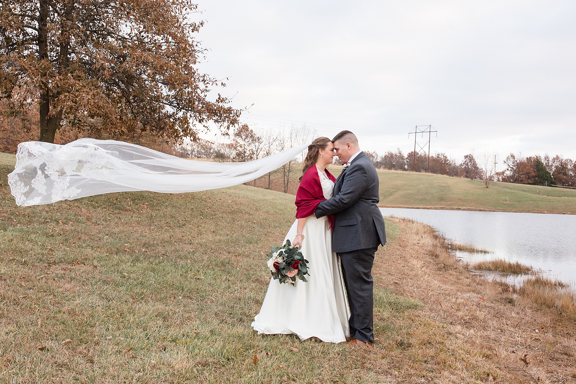 groom touches noses with bride during Redemption Ranch wedding photos