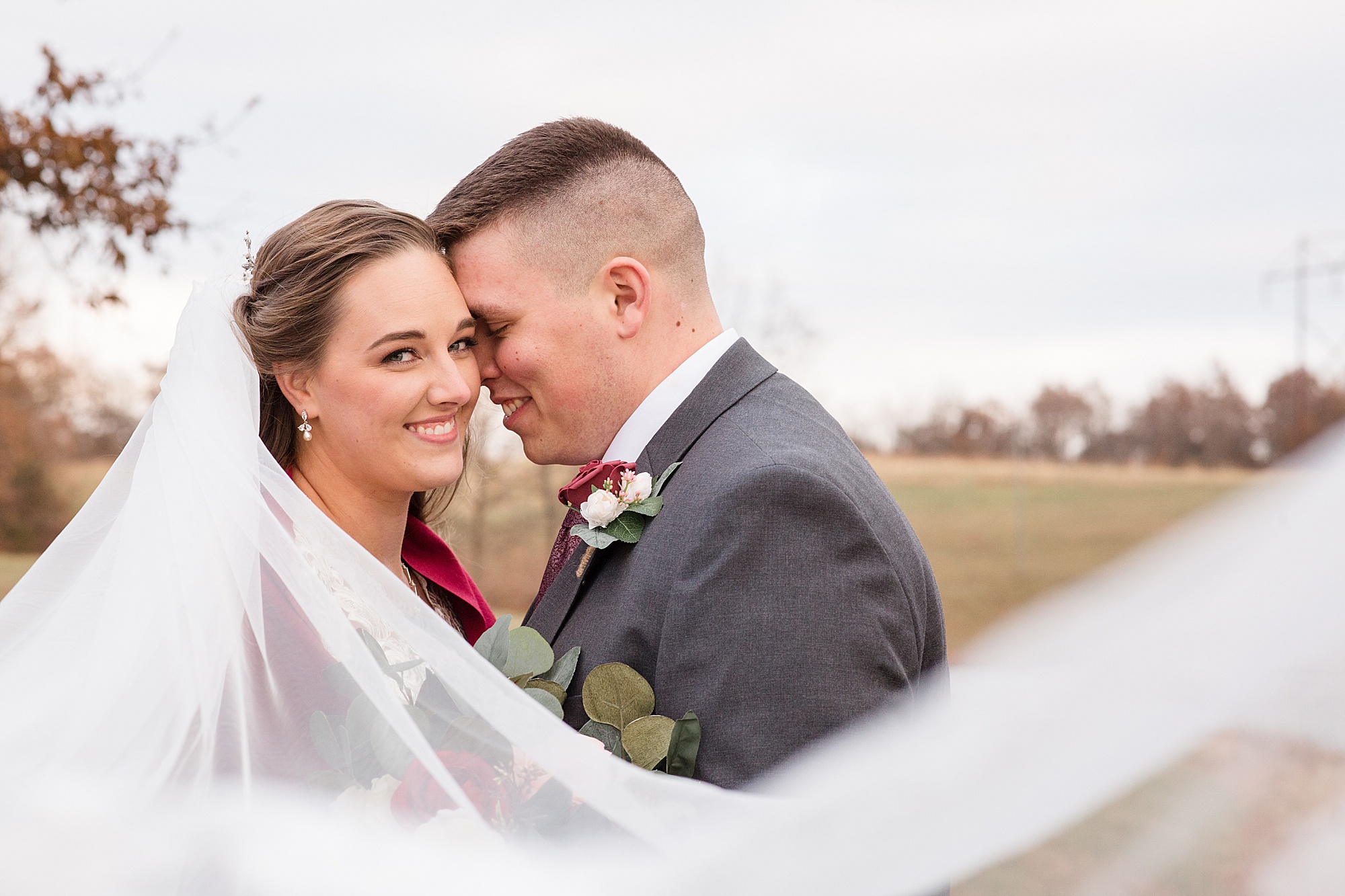 groom nuzzles bride's cheek during MO wedding photos