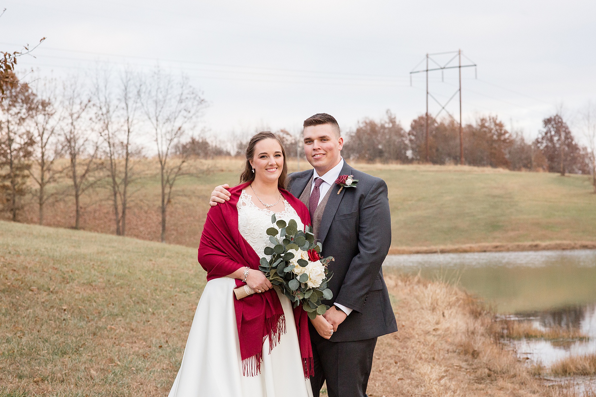 newlyweds stand by lake in Winfield MO