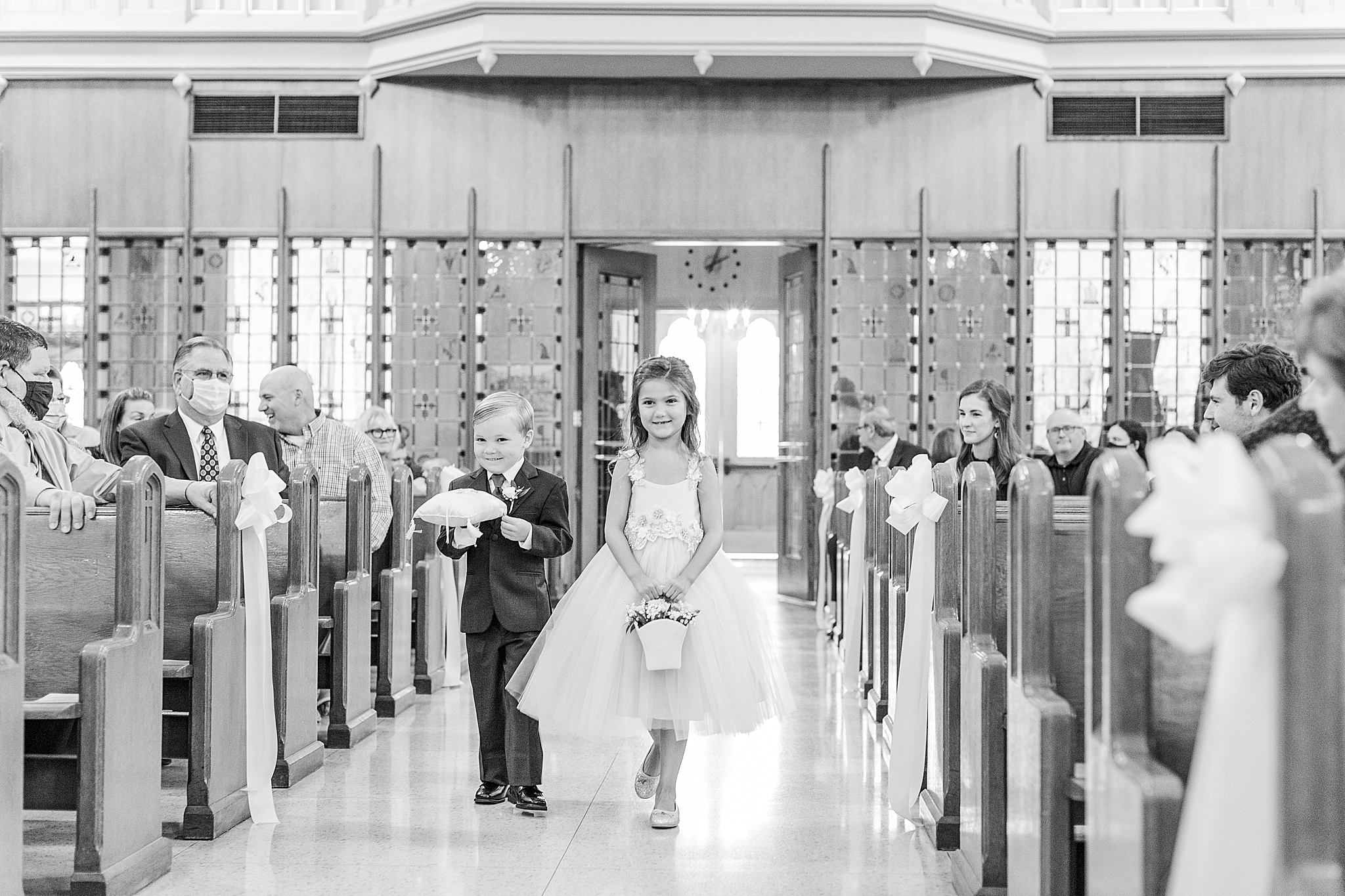 flower girl and ring bearer walk down aisle at Sacred Heart Catholic Church of Florissant