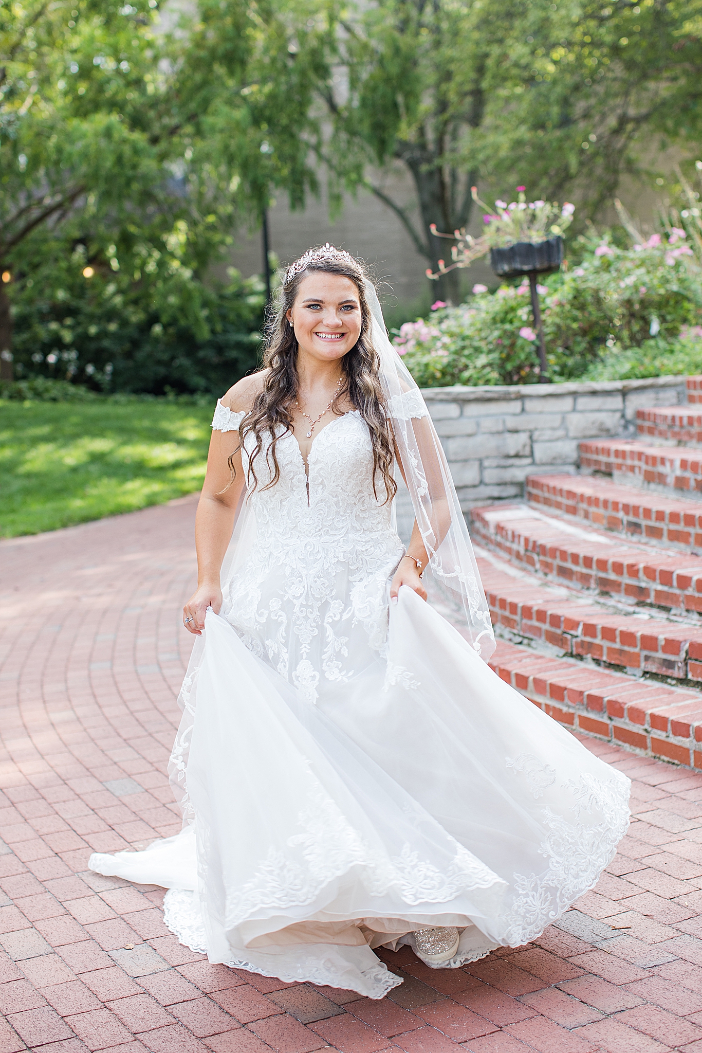 bride twirls wedding gown on brick staircase