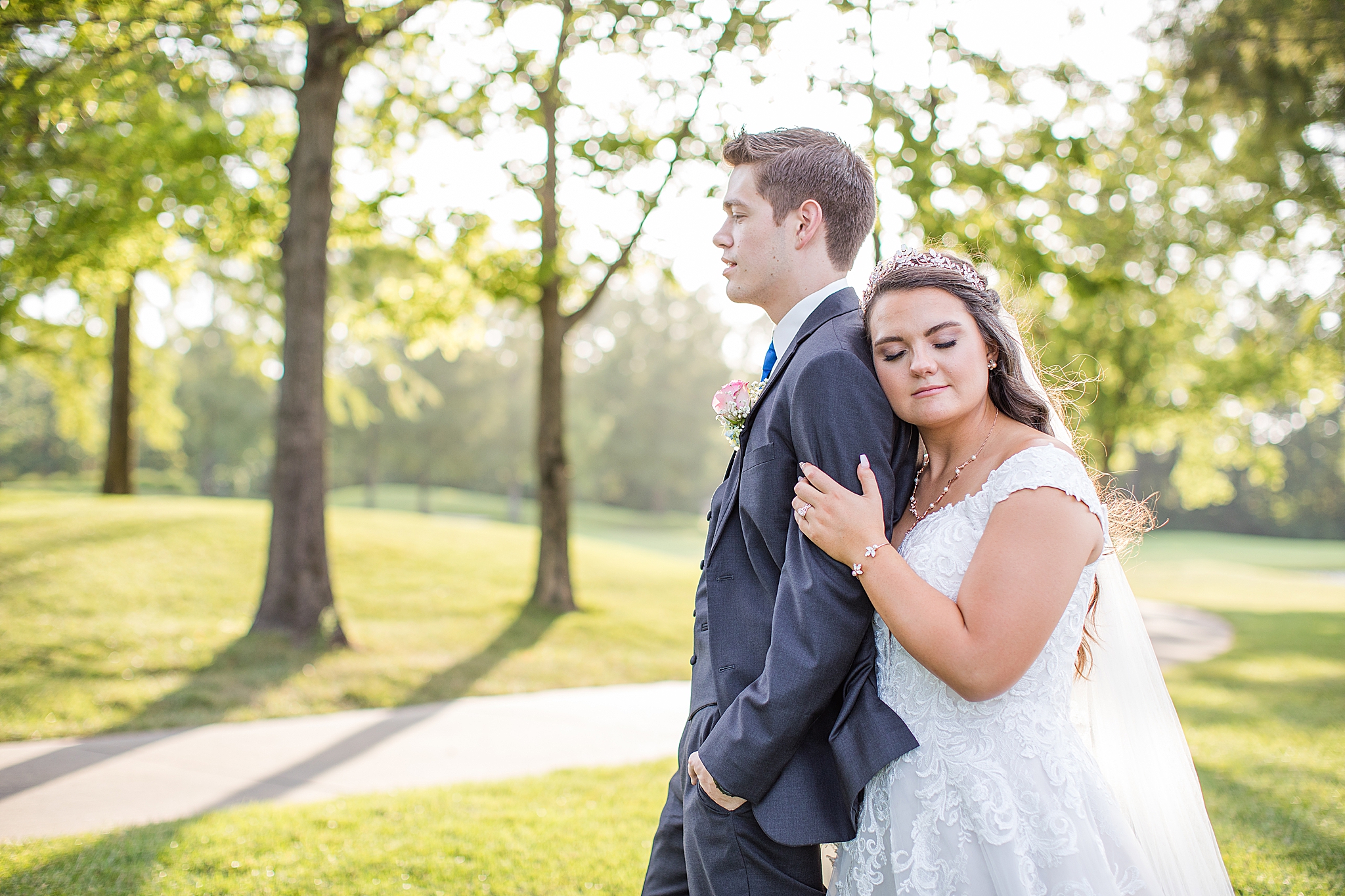 bride leans against groom during MO wedding photos