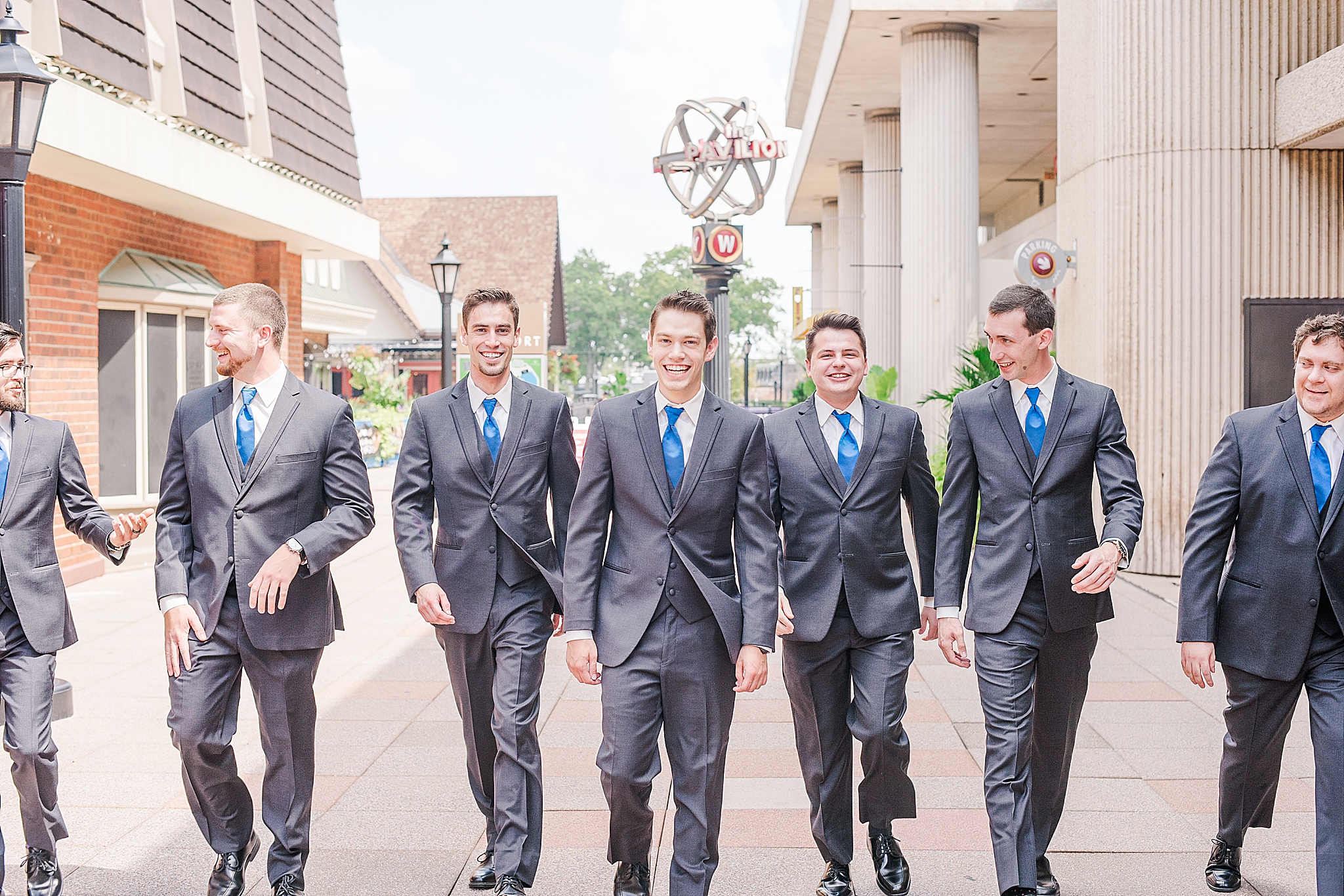 groom and groomsmen pose in downtown St Peters MO