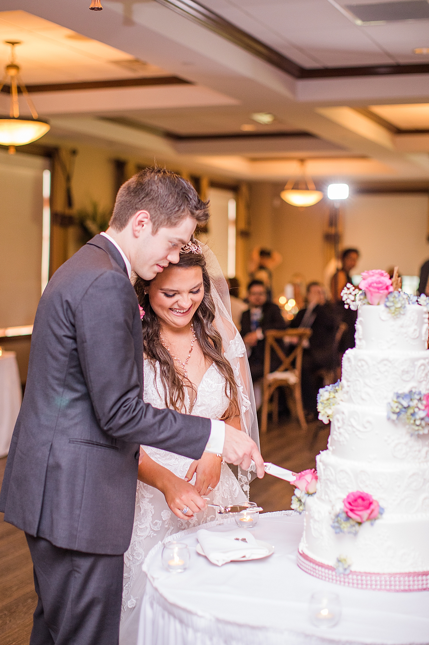 couple cuts wedding cake during Old Hickory Golf Club wedding reception
