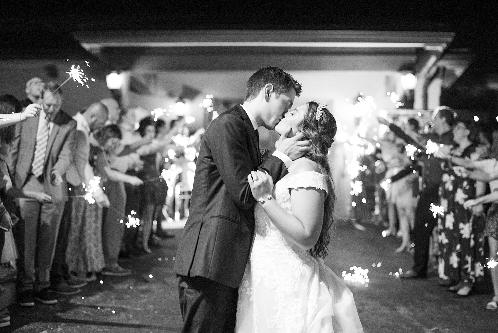 couple kisses during sparkler exit from MO wedding