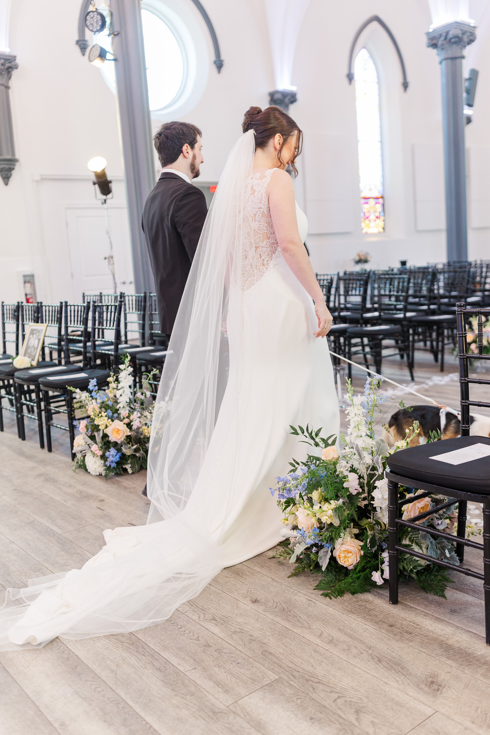 bride and groom walking back down the aisle at Main Street Abbey