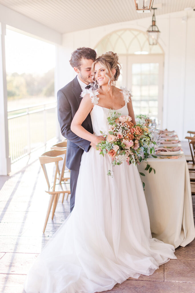 a bride and groom share an intimate moment before the reception on the veranda of westwind hills in Pacific, MO