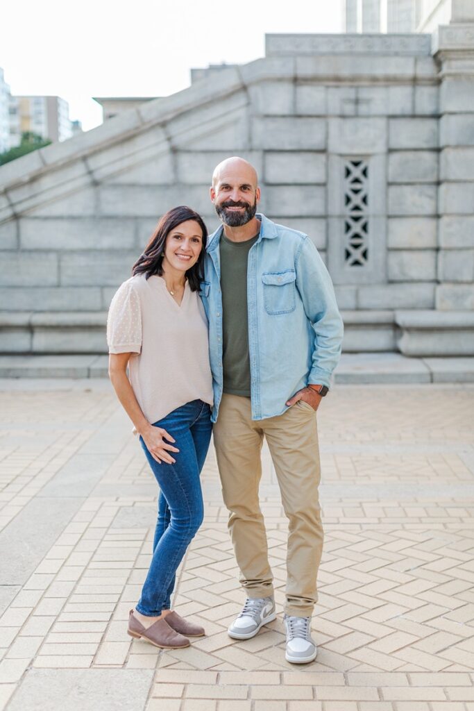 portrait of a couple standing near the St. Louis Public Library’s main arched doorways for a fall mini session.
